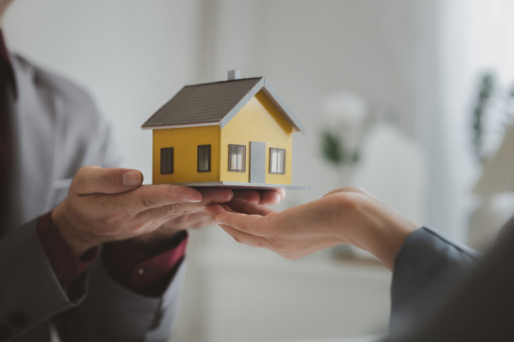 Mini house figurine on hand